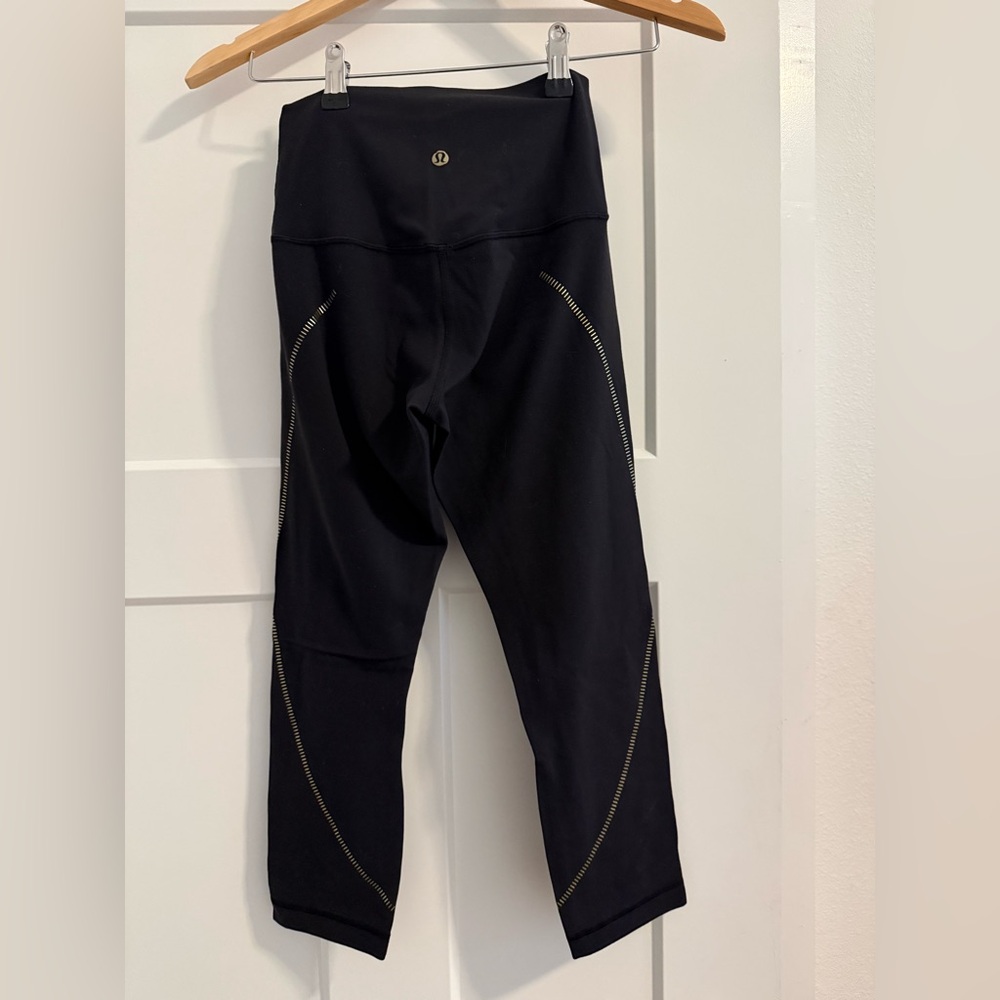 lululemon black cropped high-rise leggings with gold reflective accents